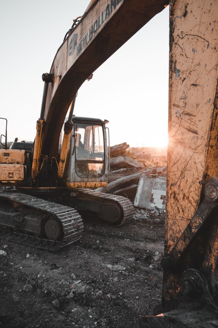 Heavy machinery at a construction site at sunset, showcasing industrial strength and raw power.
